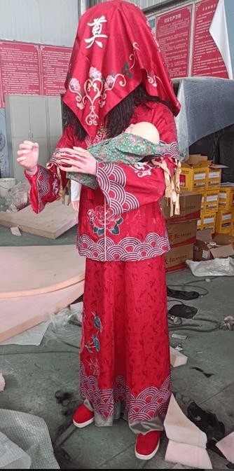 Chinese ghost bride animatronic wearing red dress and holding baby doll