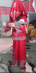 Chinese ghost bride animatronic wearing red dress and holding baby doll
