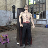 electric shock zombie animatronic strapped to panel with exposed chest