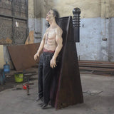 electric shock zombie animatronic strapped to panel with exposed chest