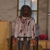 standing bloody zombie animatronic with long hair and screaming expression
