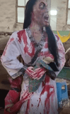 Chinese ghost bride animatronic holding baby with blood-stained gown and screaming face
