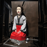 Sitting lady ghost animatronic with red dress and pale face for haunted house
