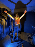 Standing evil clown animatronic with outstretched arms and laughing face for haunted house

