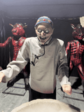 Animatronic ghost granny with spoon and evil smile in Chinese haunted house setting