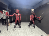 Animatronic bull head and horse face ghost guards holding tridents in a haunted house