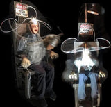 zombie animatronic in electric chair with flashing lights and head wires