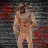 Evil clown animatronic holding doll with violent motion in haunted carnival scene