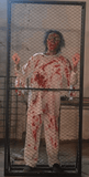 cyclops zombie animatronic banging on metal fence inside haunted room
